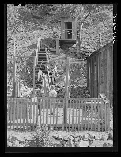 Untitled photo, possibly related to: Backyard of house with steps leading up the hill to privy. Mogollon, New Mexico