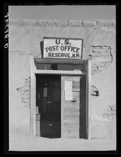 Entrance to adobe post office at Reserve, New Mexico. Reserve is the county seat of Catron County, a county in which no railroad enters