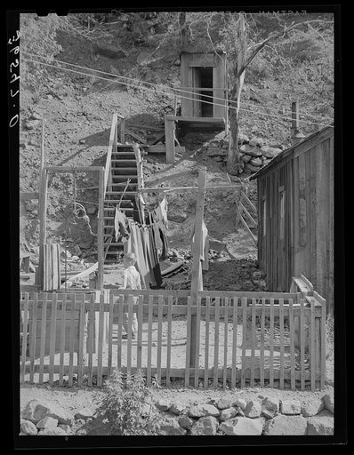 Backyard of house with steps leading up the hill to privy. Mogollon, New Mexico