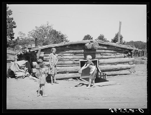 Children playing in front of dugout. Pie Town, New Mexico