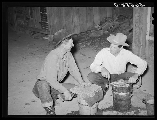 Farmers freezing ice cream. Pie Town, New Mexico. There is no ice in the town. Two or three farmers have built ice storage houses of wooden blocks, packing the ice in sawdust. When someone makes the thirty or forty mile trip for ice, several families get together for an ice cream party