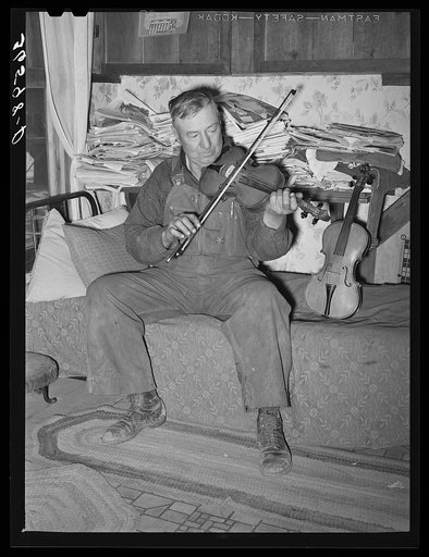 George Hutton, farmer from Maud, Oklahoma, playing his violin which he made. Pie Town, New Mexico