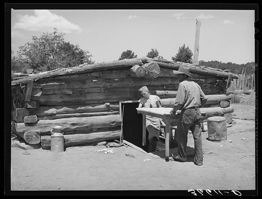 Mr. and Mrs. Faro Caudill bringing a table from their dugout. They are rebuilding their dugout nearer their water well, garden and stocklots. Pie Town, New Mexico