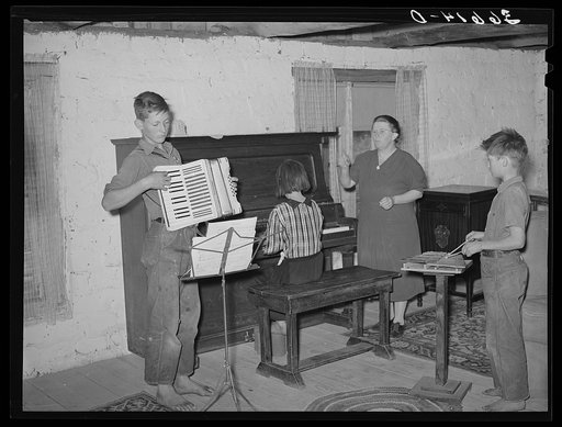 Wife of a homesteader with her WPA (Work Projects Administration) music class. These children walk eight miles for their music lessons. Pie Town, New Mexico