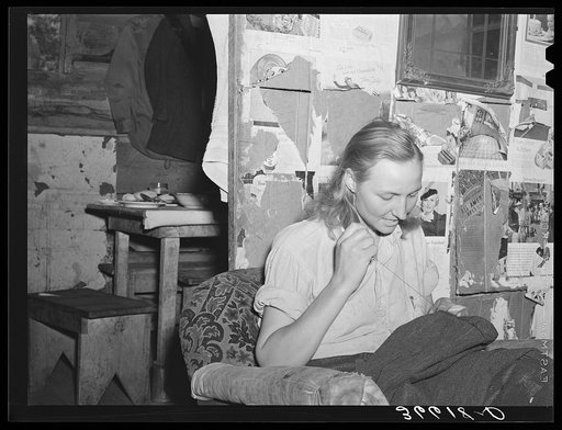 Mrs. Faro Caudill patching her husband's trousers. Pie Town, New Mexico