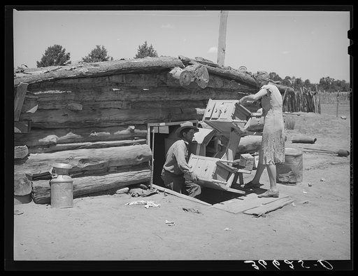 Mr. and Mrs. Caudill moving furniture from their dugout. Pie Town, New Mexico