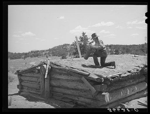 Pie Town, New Mexico. A community settled by about 200 migrant Texas and Oklahoma farmers who filed homestead claims. Faro Caudill taking down the chimney from his dugout before he tears down the dugout