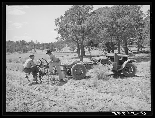 Farmer and his younger brother with tractor which has been adapted from truck. Pie Town, New Mexico