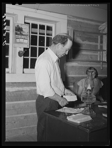 John Adams reading his part of the program at the literary society. Pie Town, New Mexico