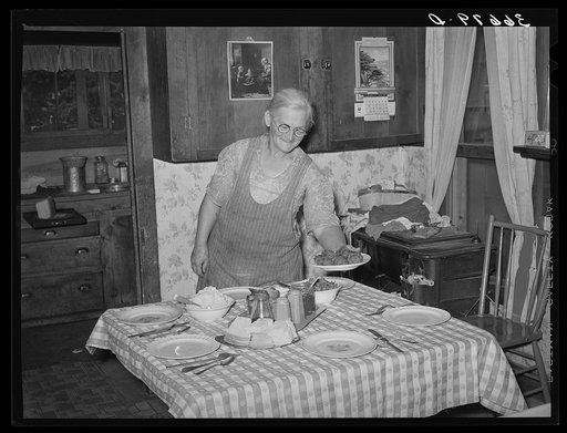 Mrs. George Hutton putting the food on the table for dinner. Pie Town, New Mexico