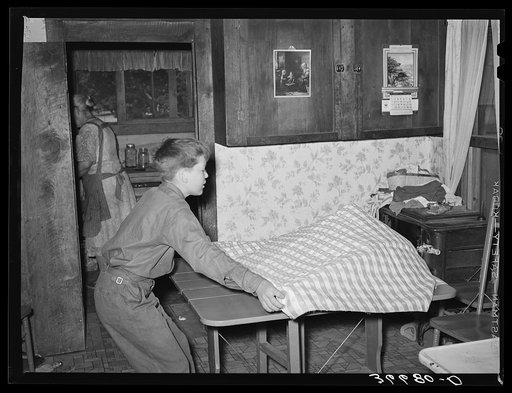 The Huttons' grandson putting on the table cloth. Pie Town, New Mexico