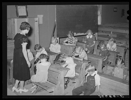 The school day opens with prayer at private school at the Farm Bureau building. Pie Town, New Mexico