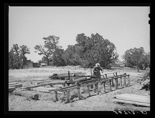 George Hutton working at the small sawmill which he built on his homestead farm. This sawmill serves not only his own needs, but many neighbors also use it. Pie Town, New Mexico