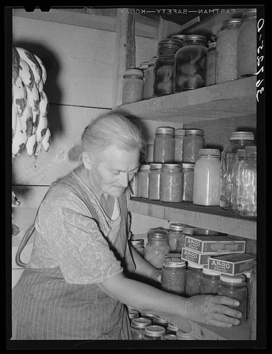 Mrs. Hutton in her storage cellar. Mrs. Hutton said, "You know it seems like a farm is the place for us old folks. In town we wouldn't be a bit of use to ourselves but out here, we can take our time about getting our work done." Pie Town, New Mexico