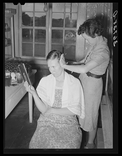 Women fix each other's hair in the absence of a beauty shop at Pie Town, New Mexico