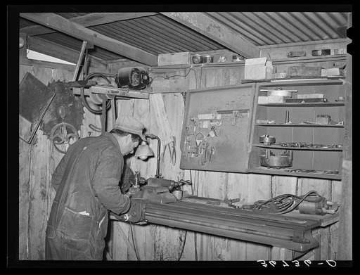 George Hutton, Jr., in the machine shop on his farm. He does all the work required on his farm equipment and also helps out his neighbors. Pie Town, New Mexico