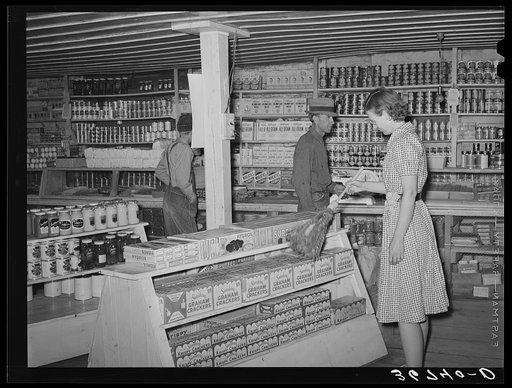 Clerk in general store dusting. Pie Town, New Mexico