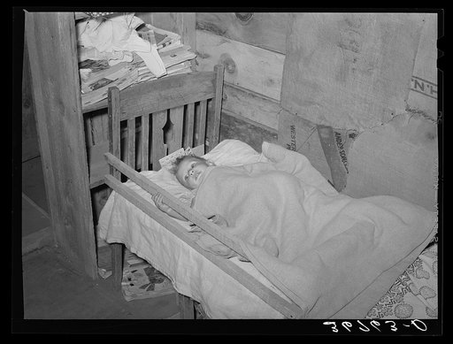 The Whinery baby in his homemade bed. Pie Town, New Mexico