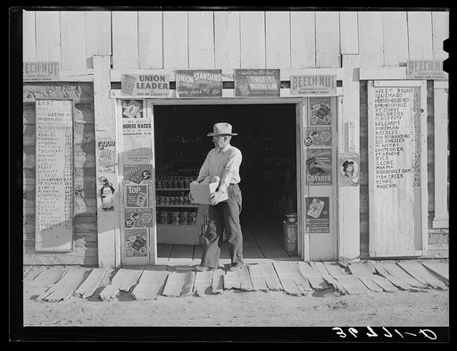 Mr. Keele, merchant and president of the Farm Bureau, in front of the general store. Pie Town, New Mexico