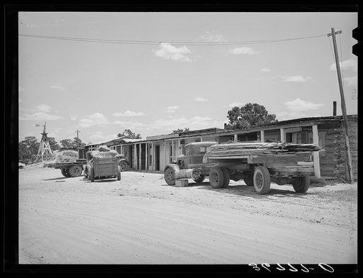 Trucks from a small sawmill stand in front of the cabins at Pie Town, New Mexico
