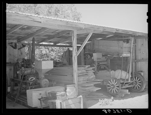 Toolshed on farm of George Hutton. Notice the homemade bean thresher at the right. Pie Town, New Mexico