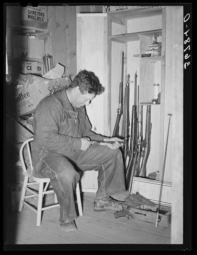 Untitled photo, possibly related to: George Hutton Jr. looking over his guns. Pie Town, New Mexico