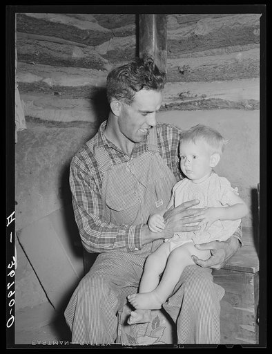 Jack Whinery, homesteader, with his baby son. Pie Town, New Mexico