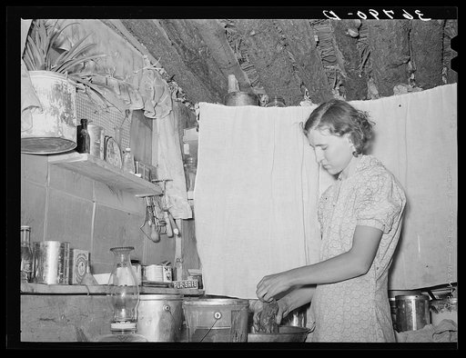 Mrs. Jack Whinery working in kitchen of her dugout. Pie Town, New Mexico
