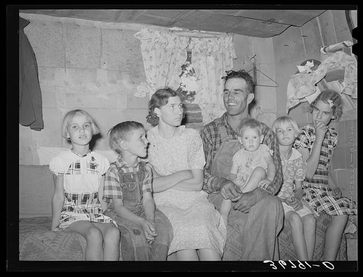 Mr. and Mrs. Jack Whinery and their five children in their dugout. Pie Town, New Mexico. Mr. Whinery had worked on farms in Texas for wages until homesteading one year ago. He arrived in Pie Town with thirty cents which he spent for nails to build his dugout. He donates his services as a preacher to