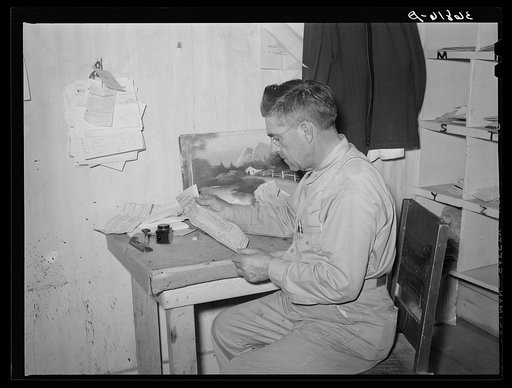 Mr. Keele looks over accounts of the general store. Pie Town, New Mexico