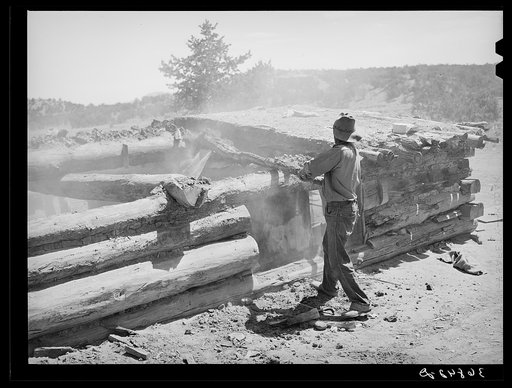 Faro Caudill tearing down his dugout. He is rebuilding his dugout nearer his water. Pie Town, New Mexico