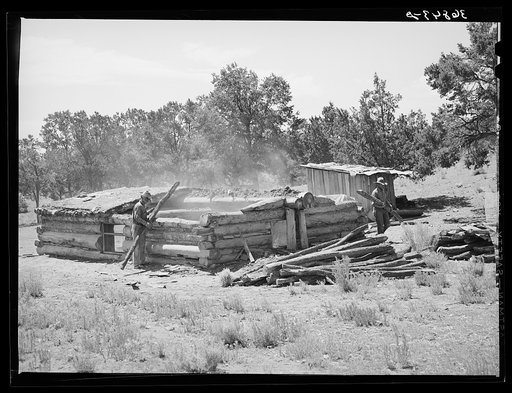 Faro Caudill and neighbor John Adams tearing down dugout. Pie Town, New Mexico