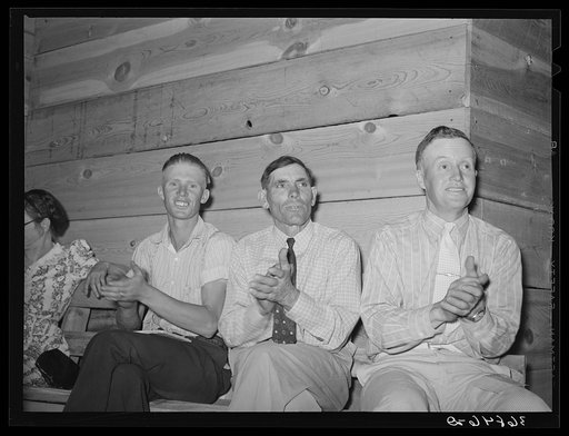 Spectators clapping for the singers. Community singing, Pie Town, New Mexico. All three men are homesteaders