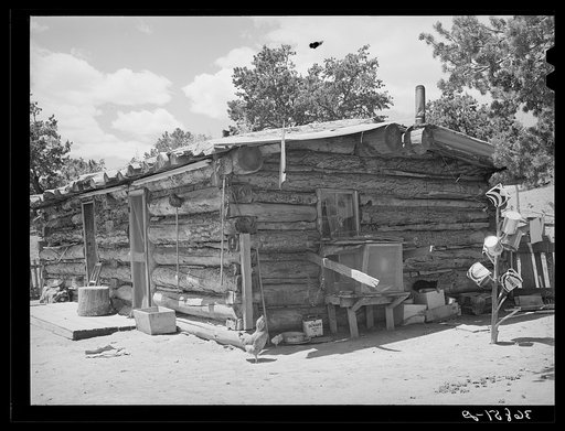 Log house built by a homesteader. This homesteader, who was deeded his farm four years ago, is now sick and lives in town, renting his house and farm to a young couple. Pie Town, New Mexico
