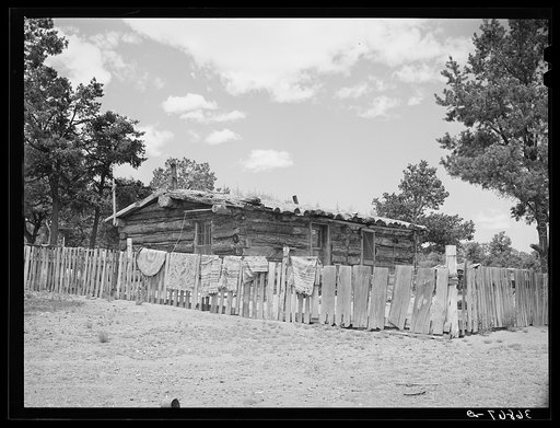 Log house of farmer with a fence of hand-split rails. Pie Town, New Mexico