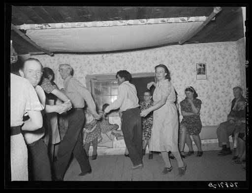 Untitled photo, possibly related to: The broom dance at the square dance. Pie Town, New Mexico. The extra girl or man dances around with a broom for a partner. Then drops broom loudly; everyone must change partners and the one left out in the exchange must then dance with the broom