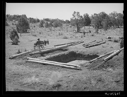 Untitled photo, possibly related to: Faro Caudill and neighbor building dugout. Pie Town, New Mexico