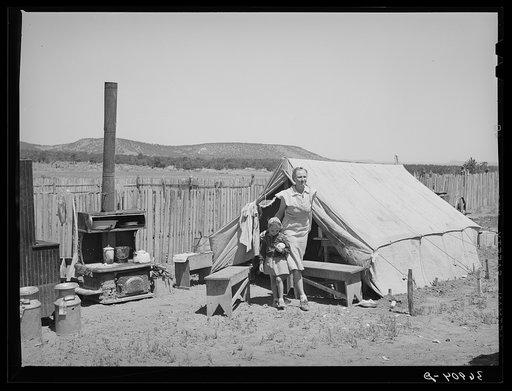 Mrs. Caudill and her daughter in front of tent which is their home while they are moving their dugout. They are leaving for Sunday school and church. Pie Town, New Mexico