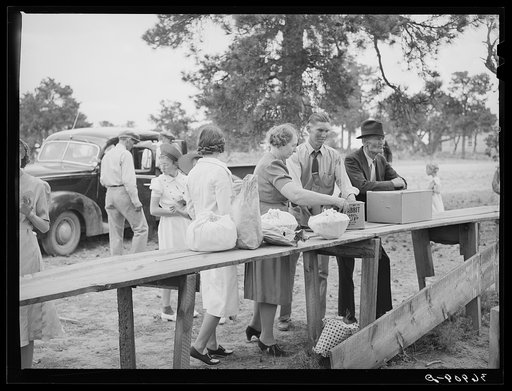 Putting out the food for "Dinner on the Grounds" at all-day community sing. Pie Town, New Mexico