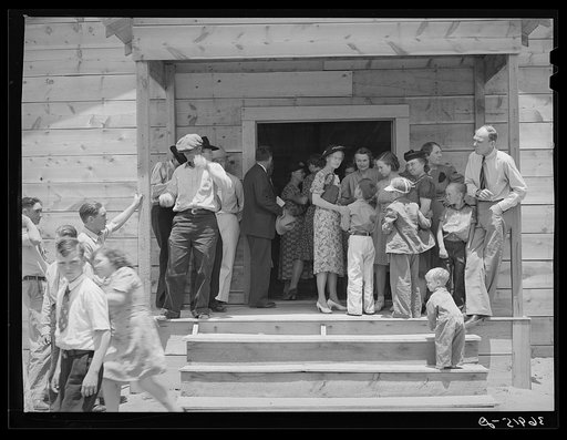 People leaving the church for dinner at the community sing. Pie Town, New Mexico