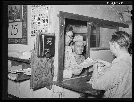 Workers at mine receiving paychecks. Mogollon, New Mexico