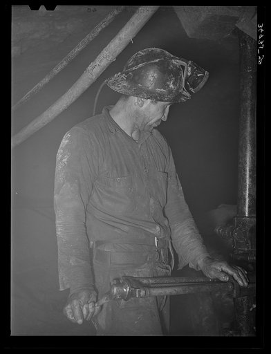 Gold miner operating pneumatic drill. Mogollon, New Mexico
