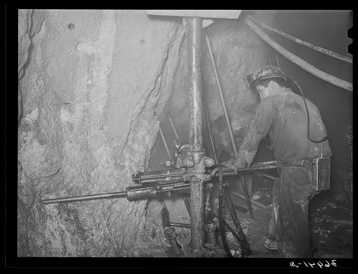 Gold miner operating pneumatic drill at Mogollon, New Mexico