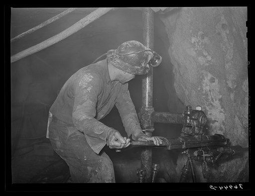 Gold miner operating pneumatic drill at Mogollon, New Mexico