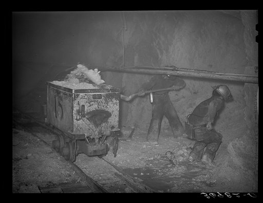 Mucking gold ore at mine. Mogollon, New Mexico