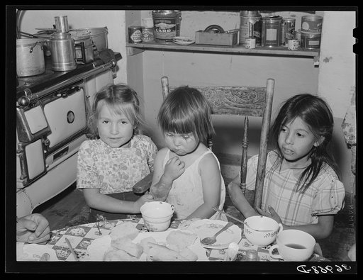 Spanish-American children at the dinner table. Chamisal, New Mexico