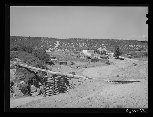 Spanish-American farn near Trampas, New Mexico. Irrigation water crosses ditch in wooden trough