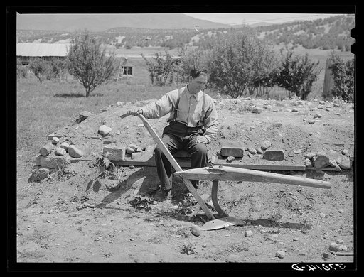 Spanish-American farmer with wooden plow which was used by his father. Chamisal, New Mexico