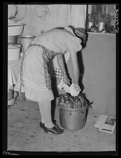 Removing jars of canned fruit from pressure cooker. Chamisal, New Mexico