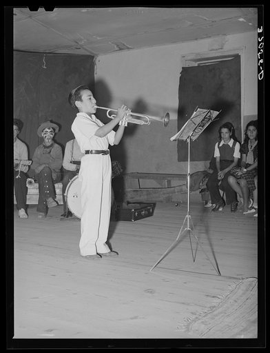Young Spanish-American musician in traveling show at Penasco, New Mexico. These traveling shows are the main source of entertainment